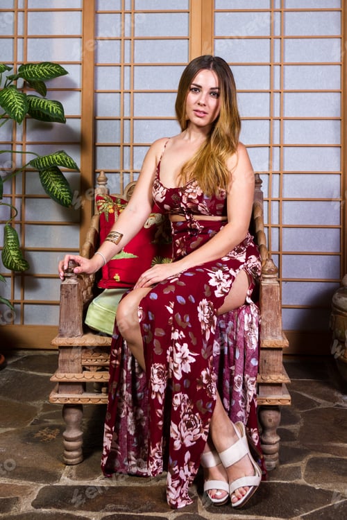 Preview: Young Costa Rican Model Posing In A Red Flowered Dress Indoors With An Asian Theme To The Picture