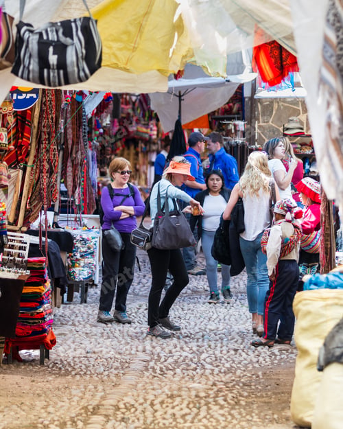 Preview: Pisac, Peru - May 15: Tourists Walking On The Alleyways Of The Market Of Pisac Looking At The