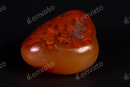 Preview: Close Up Of A Polished Piece Of Carnelian Isolated On A Black Background