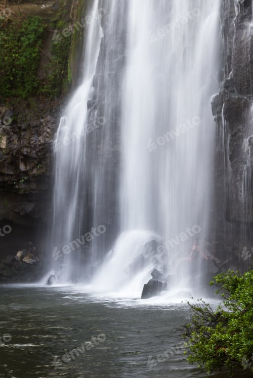Preview: Llanos Del Cortez Waterfall In Costa Rica With A Person Standing At The Base To Show The Size Of