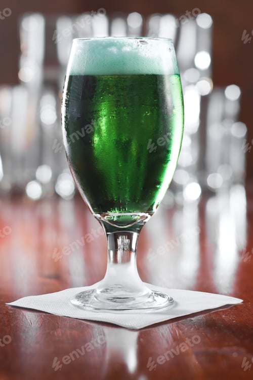 Preview: St. Patrick'S Day Green Beer Served In A Chalice On A Busy Bar