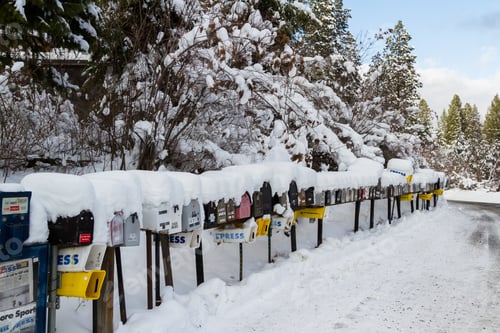 Preview: Coeur D' Alene, Idaho - December 30: Line Of Mailboxes Set Up On The Road Covered In Snow And
