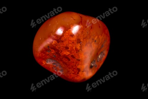 Preview: Close Up Of A Polished Piece Of Carnelian Isolated On A Black Background