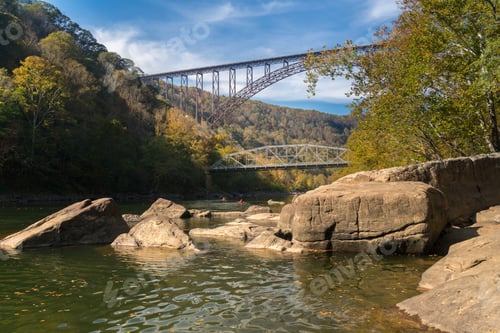 Preview: Kayakers Float Towards The Rapids Under The High Arched New River Gorge Bridge In West Virginia