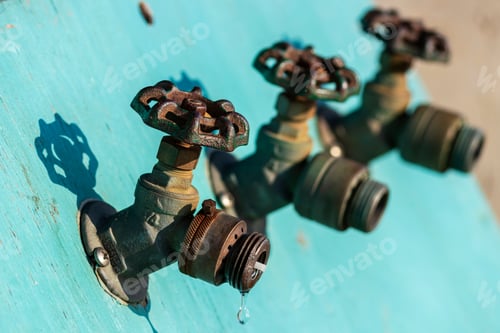 Preview: Old Faucets Spigots In Blue Turquoise Painted Plywood No Hose No Water Selective Focus