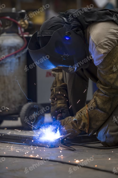Preview: Man Working With Metal, Welding. Sparks Everywhere. Mask