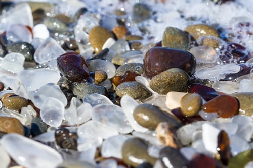 Preview: Close Up Of A Section Of Seagrass And Pebbles As The Tide Comes In Smoothing And Polishing The Rocks