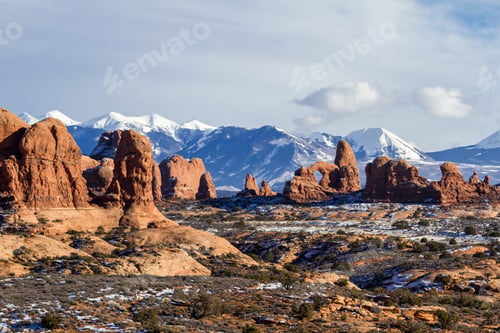 Preview: Interesting Red Rock Formations Of Arches National Park With Snow Caped Mounting In The Background