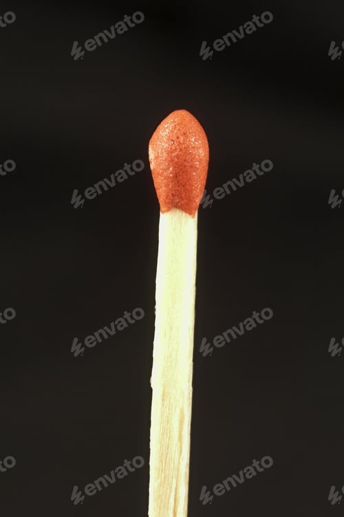 Preview: Single Red Tipped Matchstick Isolated Against A Black Background