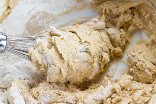 Preview: Close Up Of A Whisk Mixing Ingredients To Make Cookie Dough