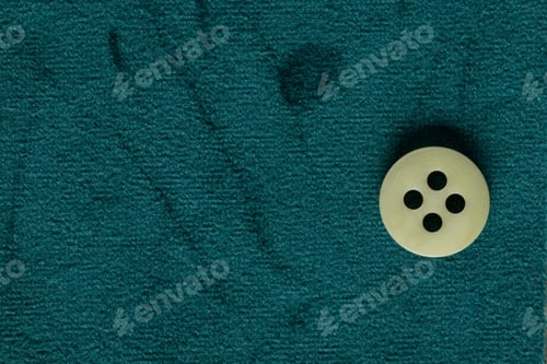 Preview: Clothes Sewing Button On A Blue Green Fabric Swatch Background