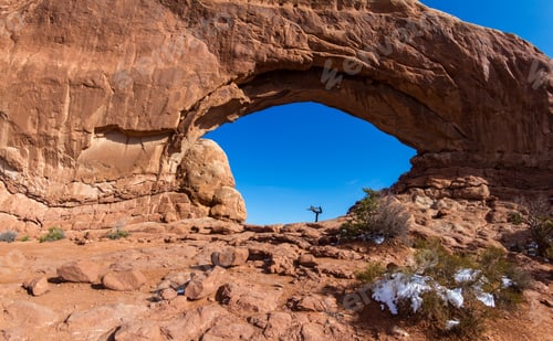 Preview: Woman Doing A Yoga Balancing Pose In North Window With A Deep Blue Sky In The Background