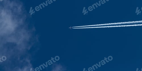 Preview: Airplane Leaving A Dense White Trail Over A Beautiful Blue Sky