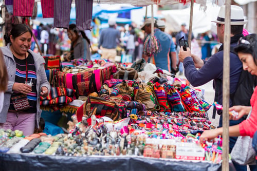 Preview: Pisac, Peru - May 15: Tourists Shopping For Souvenirs And Local Crafts At The Sacred Valley Market
