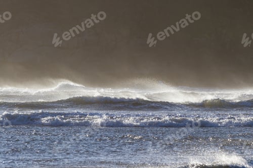 Preview: A Windy Day At The Coast With A Spray Or Mist Blowing From The Top Of The Waves As The Strong