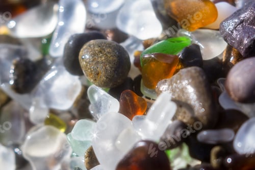 Preview: Close Up Of A Group Of Shiny Pieces Of Sea Glass On The Beach Using A Star Filter To Obtain A