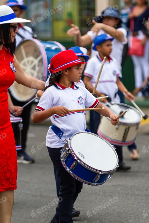 Preview: Tilaran, Costa Rica - September 15 : School Children Marching In The Town Square Playing Percussion