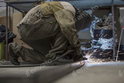 Preview: Man Working On The Floor, Welding, With Mask And Gloves For Protection. Handwork.