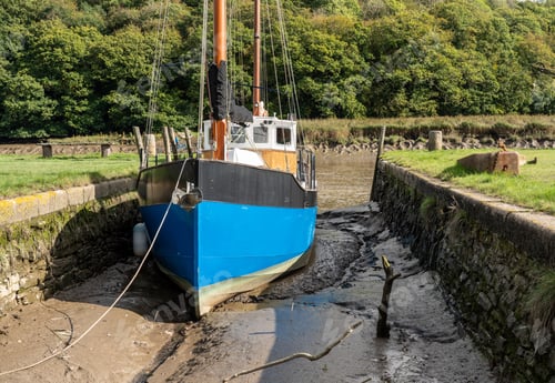 Preview: Blue Fishing Boat In Small Quay Off The Tidal River Tamar At Cotehele In Devon