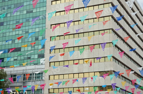 Preview: Rows Of Colorful Traditional Bunting In Front Of Modern Office Building Facades In Downtown