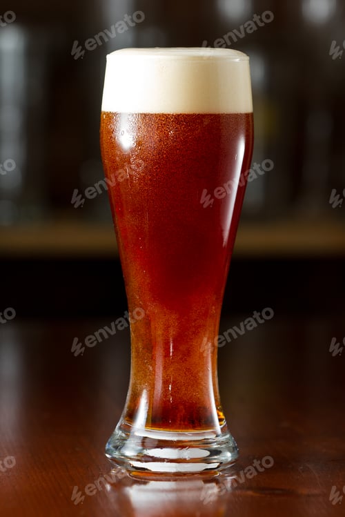 Preview: Refreshing Cold Brown Ale Beer Served In A Chilled Glass On A Dark Bar