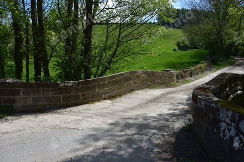 Preview: Stone Bridge On A Hiking Trail Through Woods In Northern England.