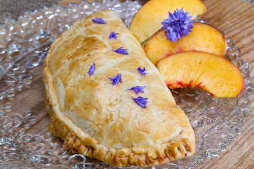 Preview: Home Made Peach Turnover Served With Slices Of A Fresh Peach