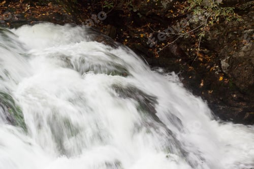 Preview: Cascading Water Over And Around Rocks Outdoors