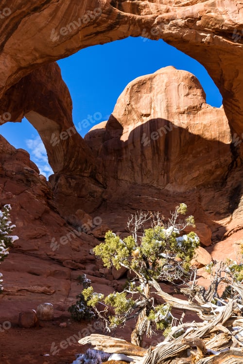 Preview: Double Arch With A Bit Of Snow In The Ground And People Under The Arch Giving It Proper Size