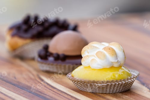 Preview: Serving Of Three Small Desserts On A Table, Focus On The Lemon Meringue