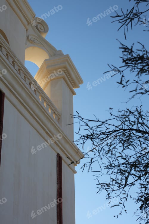 Preview: A White Stone Roofline And Branches Against A Cerulean Blue Sky 4725