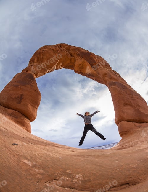 Preview: Hiker In Celebratory Jump After Arriving At This Beautiful Red Rock Arch In Arches National Park