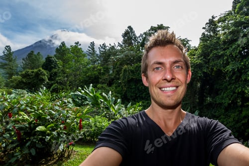 Preview: Young Man Taking A Self Portrait With The Famous Arenal Volcano In The Background