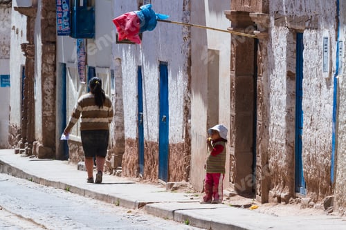 Preview: Maras Peru -May 18 : Young Boy Standing Outside Of His Door Eating Fresh Fruit With A Traditional