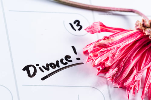 Preview: The Word Divorce Hand Written On A Dry Erase Calendar With A Dead Flower Next To It