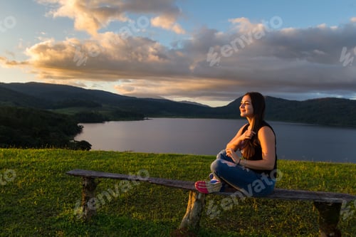Preview: Young Woman Posing For Pictures With Cote Lake In The Background As The Soft Sun Light Adds A Soft