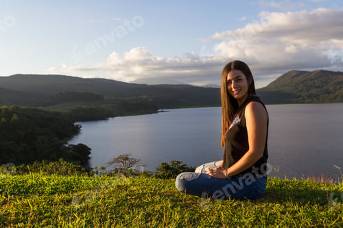 Preview: Young Woman Posing For Pictures With Cote Lake In The Background As The Soft Sun Light Adds A Soft
