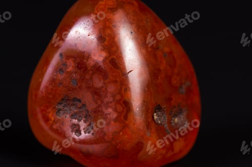 Preview: Close Up Of A Polished Piece Of Carnelian Isolated On A Black Background