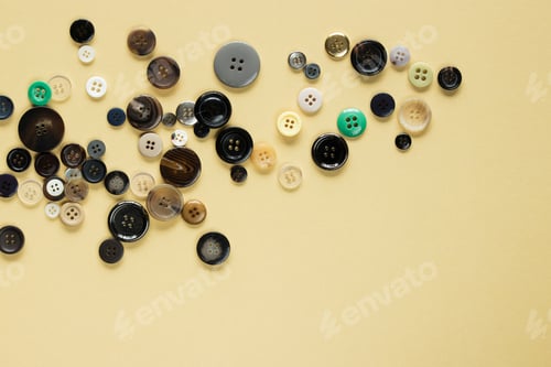 Preview: Multi Colored Clothes Sewing Buttons On Beige Background