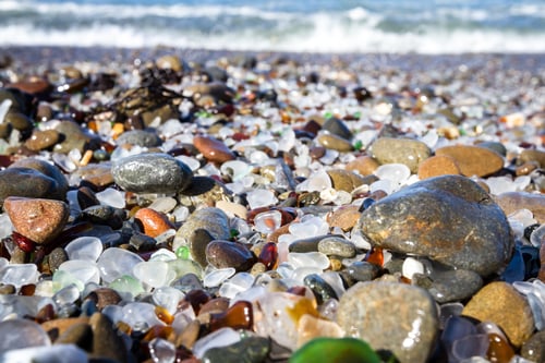 Preview: Beautiful Sea Glass In A Variety Of Colors With Blue Waves And Sky In Fort Bragg, California