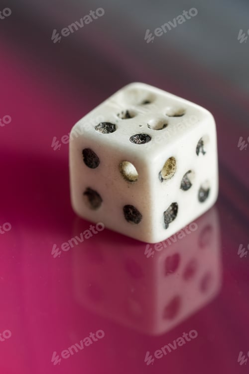 Preview: Close Up Of An Old Used Dice On A Beautiful Polished Sliced Stone
