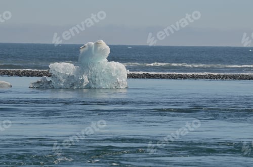 Preview: Stunning View Of A Unique Iceberg With Black Sand In The Background