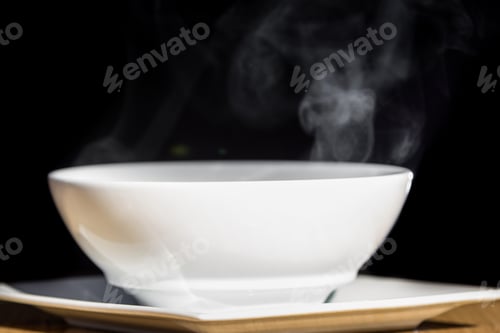 Preview: Close Up Of A Steaming White Bowl Isolated On A Black Background