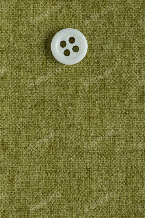 Preview: Clothes Sewing Button On A Green Fabric Swatch Background