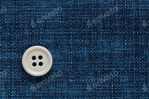 Preview: Clothes Sewing Button On A Blue Fabric Swatch Background