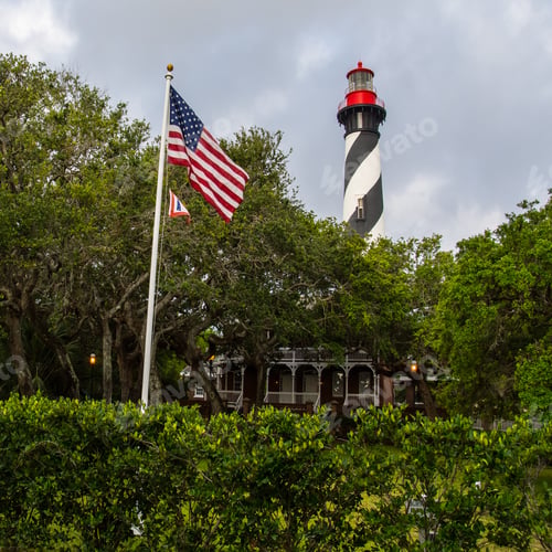 Preview: The St. Augustine, Florida, Lighthouse With The American Flag Waving In The Foreground