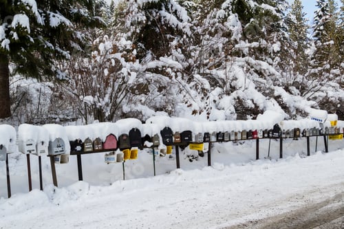 Preview: Coeur D' Alene, Idaho - December 30: Line Of Mailboxes Set Up On The Road Covered In Snow And