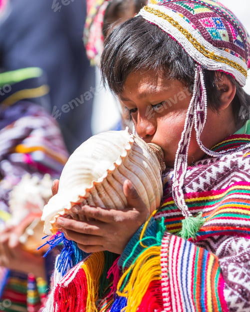 Preview: Pisac, Peru - May 15: Young Man Playing A Tune Using A Conch Shell As Part Of A Ceremony In The