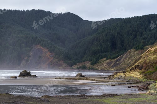 Preview: Classic Coastal Scene In The Oregon Coast With Rocks In The Sand And A Dramatic Coastline