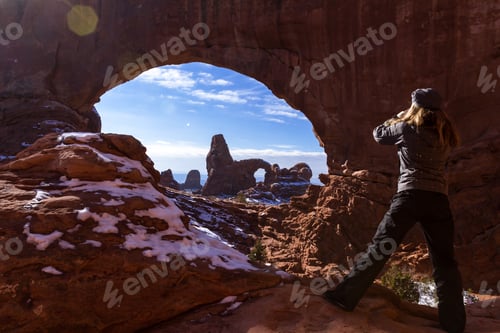 Preview: Woman In Fun Winter Gear Enjoying The View Of Turret Arch Thru North Window With Fresh Snow On The